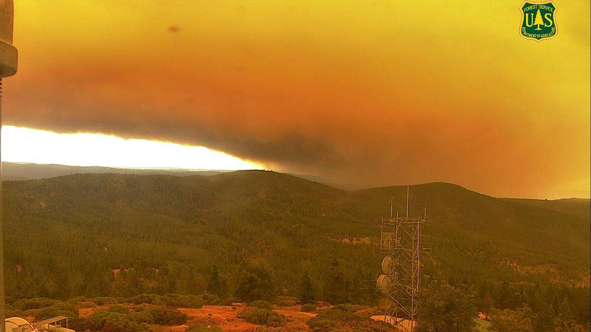 Orange smoke from the Caldor Fire as seen from the U.S. Forest Service wildfire camera at Big Hill Lookout Tower around 10:30 a.m. Tuesday, Aug. 17, 2021. The fire swelled in size overnight by 30,000 acres as of Wednesday.