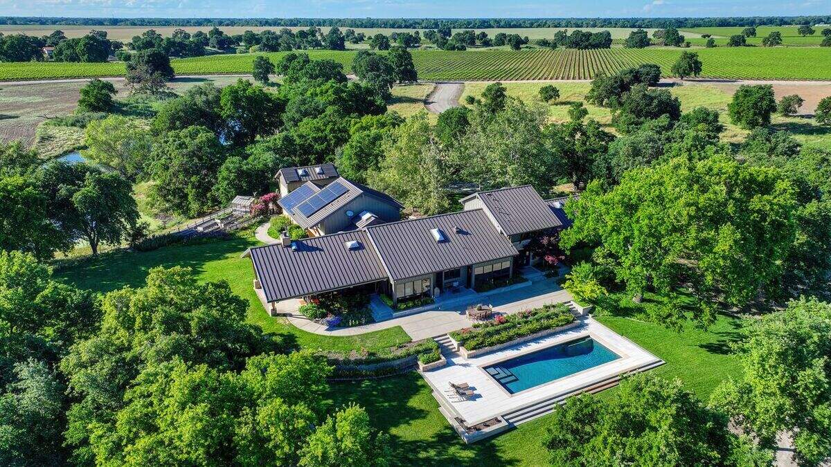 The two-acre property’s outdoor amenities include a resort-style pool, putting green with chipping pads and a lake for kayaking or paddle boarding.