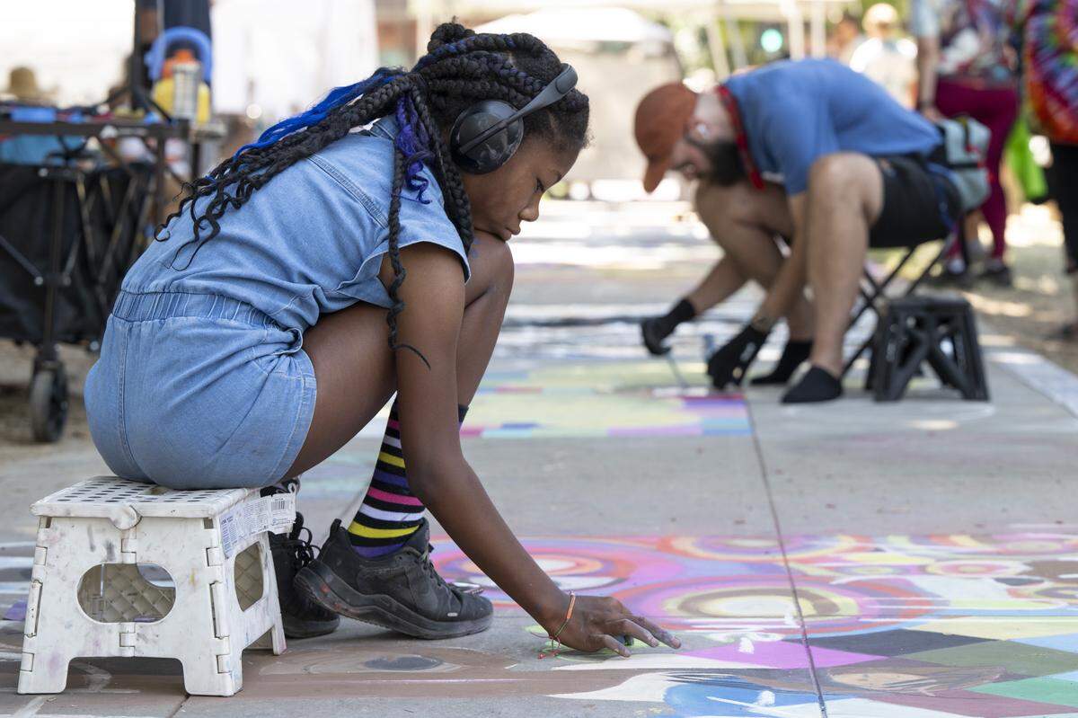 Artists work on individual chalk art pieces during Chalk It Up art festival at Fremont Park in Sacramento on Sunday, Aug. 31, 2025.
