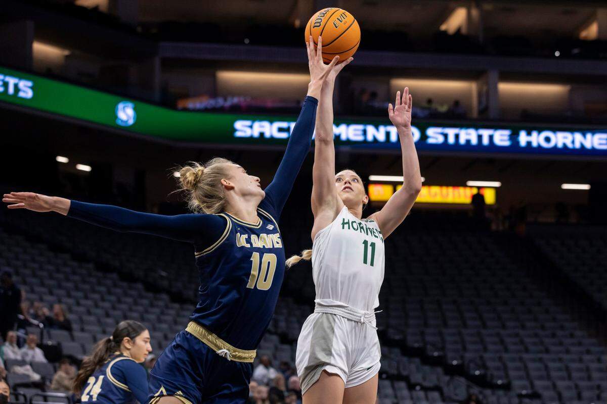 UC Davis Aggies forward Lena Svanholm (10) blocks the shot of Sacramento State Hornets guard Summer Menke (11) during the first quarter on Tuesday, Nov. 23, 2021 during a nonconference basketball game at the Golden 1 Center in Sacramento. The Aggies won 75-46.