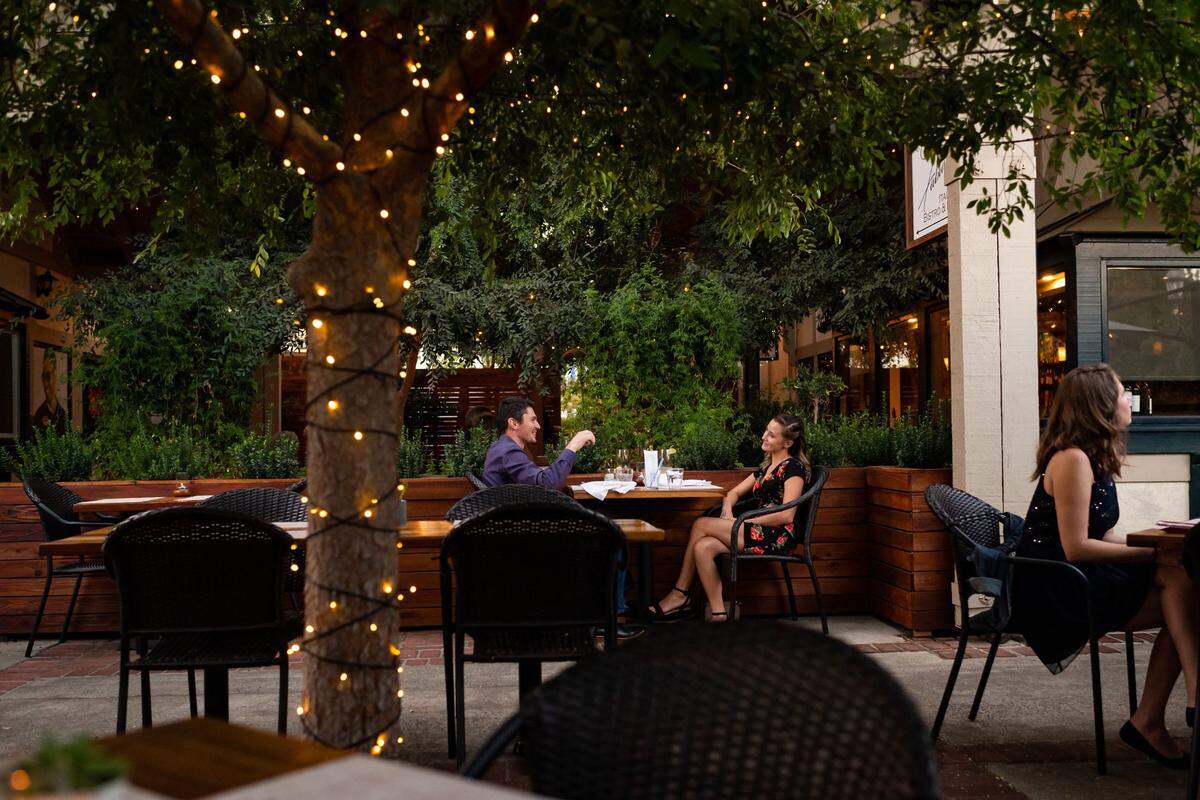 Kody Channell, left, and his wife, Janae Channell celebrate their second anniversary at Fabian’s Italian Bistro & Bar, seated in their most recent addition for outside diners, on Wednesday, Oct. 7, 2020, in Fair Oaks. Owner Christian Forte said they started building the extended area even before they learned coronavirus restrictions would affect them, and it’s helped sustain their business.