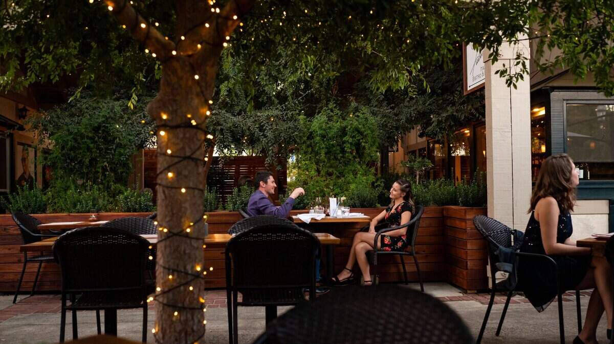 Kody Channell, left, and his wife, Janae Channell celebrate their second anniversary at Fabian’s Italian Bistro & Bar, seated in their most recent addition for outside diners, on Wednesday, Oct. 7, 2020, in Fair Oaks. Owner Christian Forte said they started building the extended area even before they learned coronavirus restrictions would affect them, and it’s helped sustain their business.