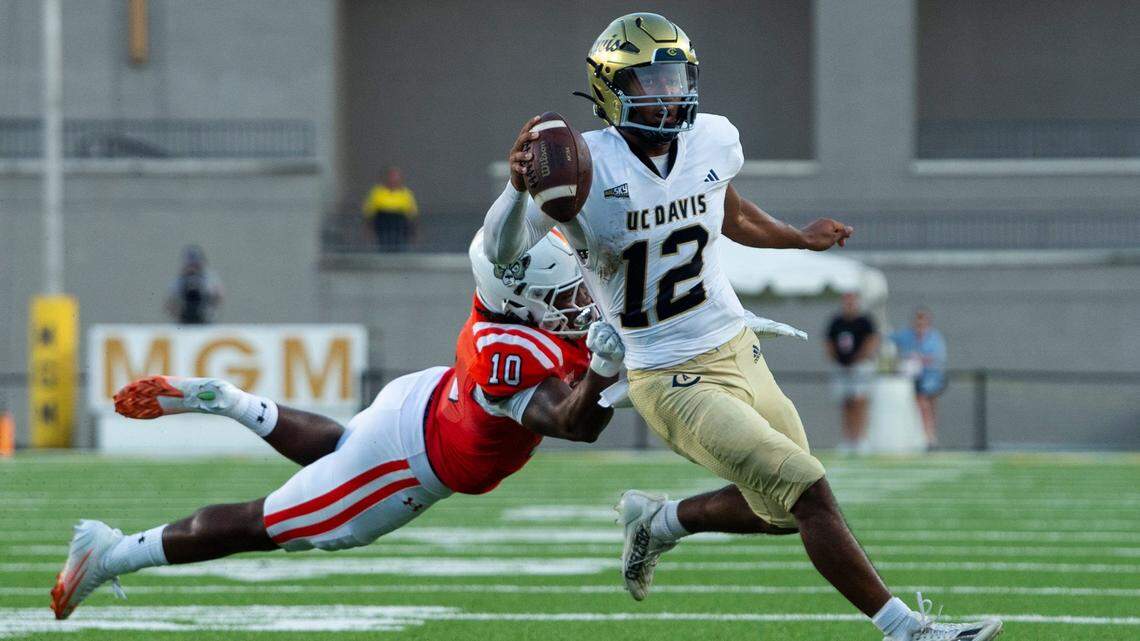 UC Davis Aggies quarterback Caden Pinnick (12) runs the ball as Mercer Bears take on UC Davis Aggies during the FCS Kickoff Game at Cramton Bowl in Montgomery, Ala. on Saturday, Aug. 23, 2025.