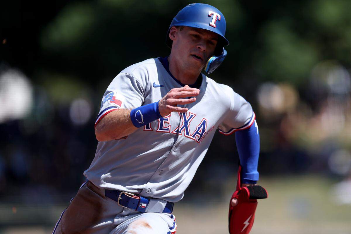 Texas Rangers center fielder Michael Helman (24) runs towards third base and scores a run against the Athletics during the fifth inning at Sutter Health Park.