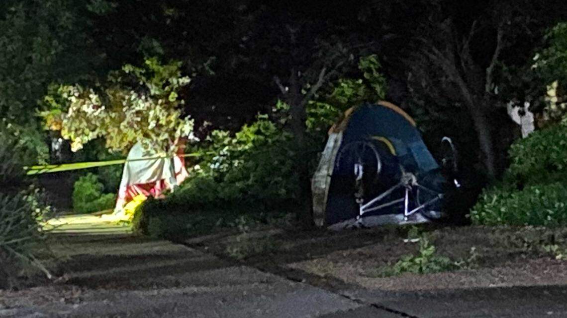 Tents near the scene of a stabbing are blocked by law enforcement vehicles and police tape following a stabbing Monday night at a homeless encampment near 2nd and L streets in Davis. It was the third stabbing in the city in less than a week.