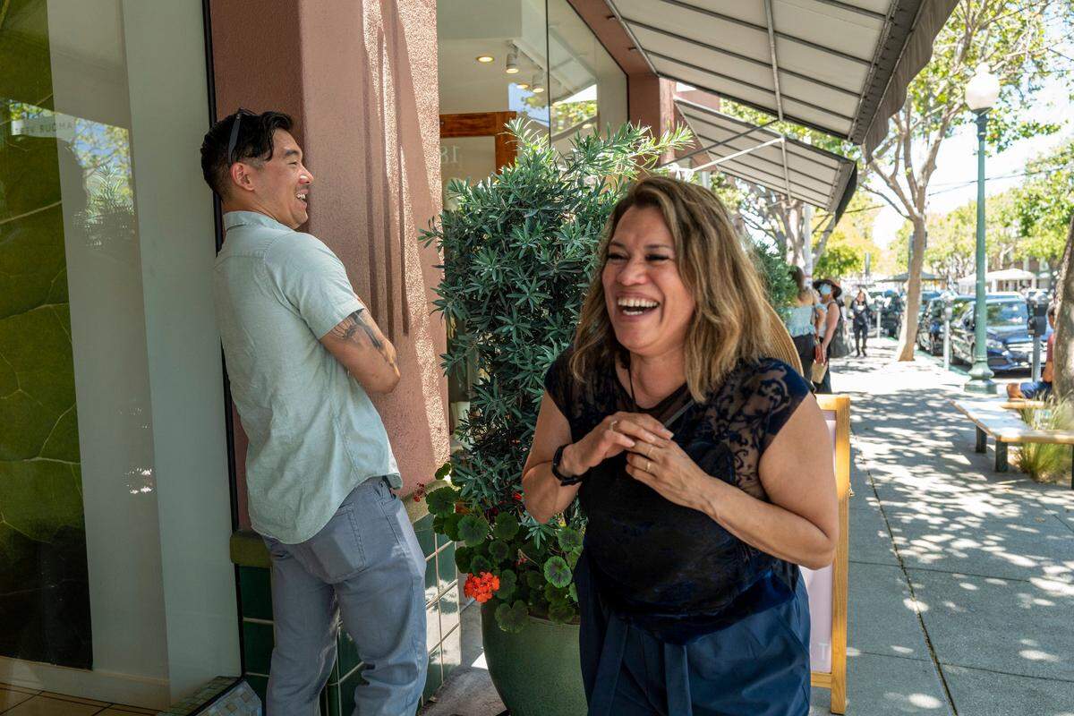 Norma Cumpian, 52, right, and her son Anthony Cumpian, 29, burst into laughter after a passerby remarked “nice couple,” in Berkeley earlier this month. While she was incarcerated, Cumpian worked to maintain a connection with her son, who grew up to become a combat veteran in Afghanistan and was awarded a Purple Heart.