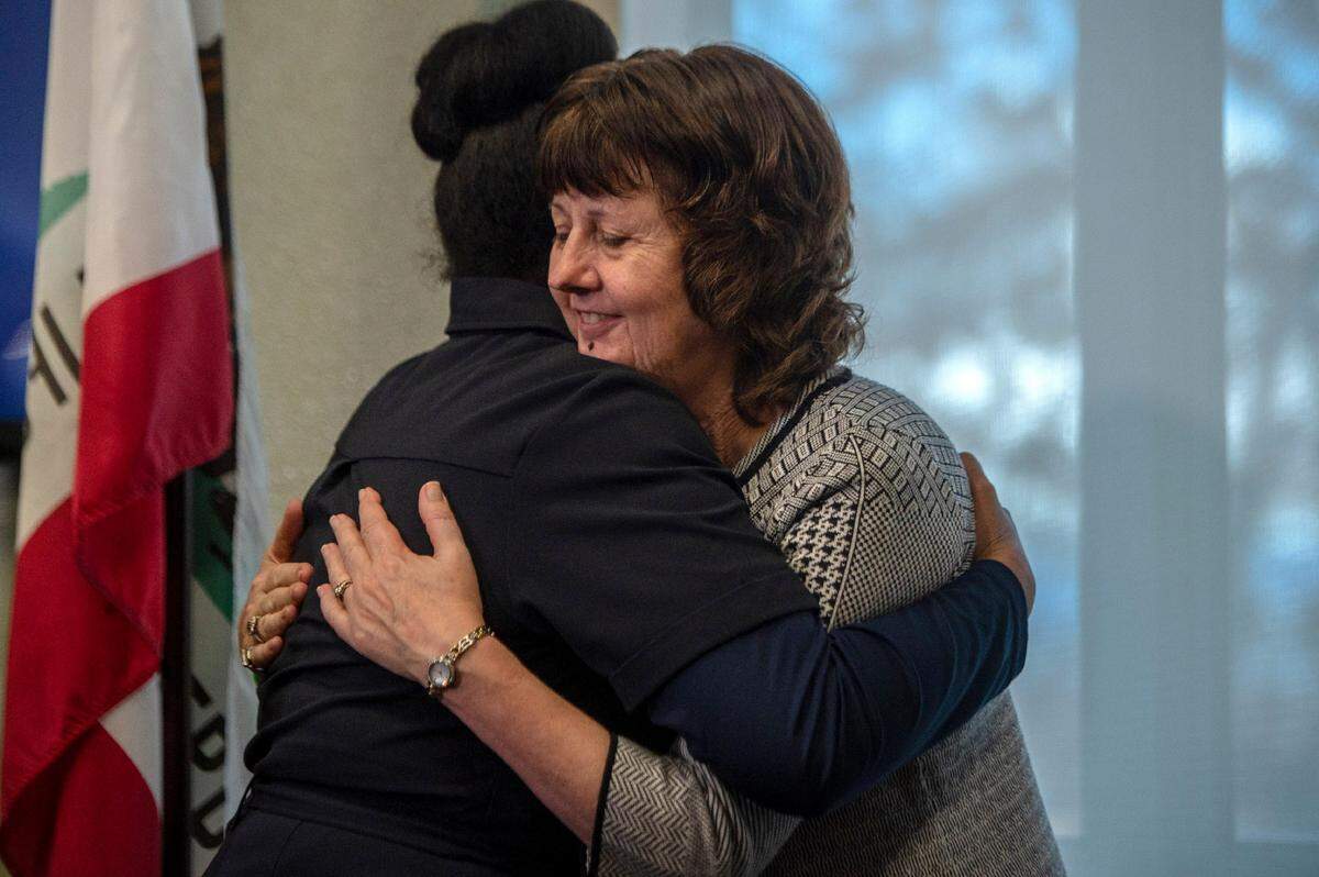 Jody Jones, right, the mayor of Paradise, is hugged after a press conference following the first day back to school after the Camp FIre for students from her city on Dec. 2, 2018 in Oroville.