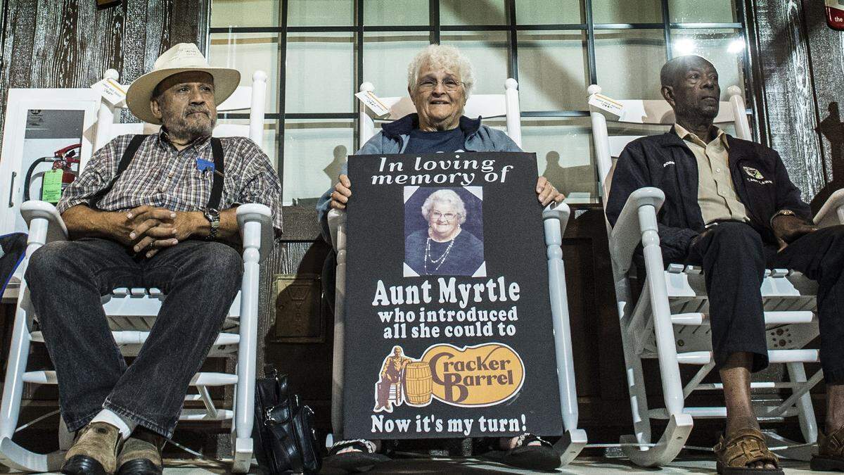 Rosalie Vierra of Sacramento center holds a sign with a picture of her aunt Myrtle, who introduced her to Cracker Barrel, during the 2018 grand opening of the restaurant in Arden Arcade. Vierra said she cut her vacation in Yellowstone National Park short to be at the opening.