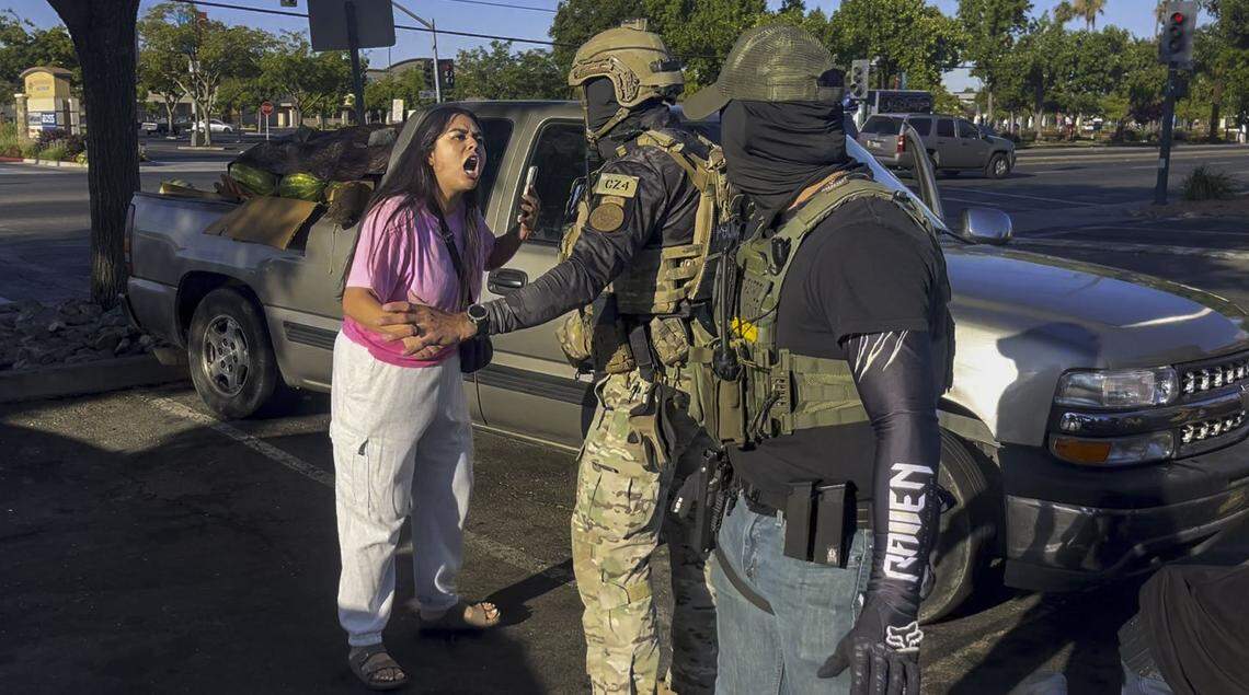 In an image from video, Andrea Castillo yells at a U.S. Border Patrol officer as her husband Jose is detained after he was pepper sprayed at the Florin Road Home Depot in south Sacramento on Thursday, July 17, 2025.