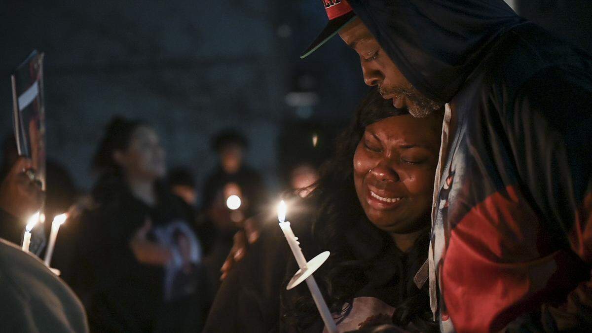 Britani Frierson is hugged by her uncle, Derek Charles, during a candlelight vigil for her 10-year-old son, Keith “KJ” Frierson on Tuesday, Jan. 30, 2024, at the Hillsdale Oaks condo community of Foothill Farms where he was shot and killed on Dec. 30. The boy accused of firing the gun will not be charged but his father, who left the gun in a car, faces multiple charges. The photograph received the first-place award in the news category.