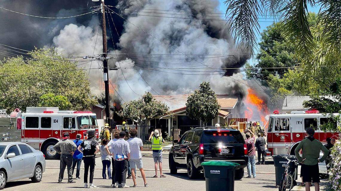 Three firefighters suffered mild electrical injuries Friday afternoon while battling a blaze that engulfed two homes in Orange, California, officials say.