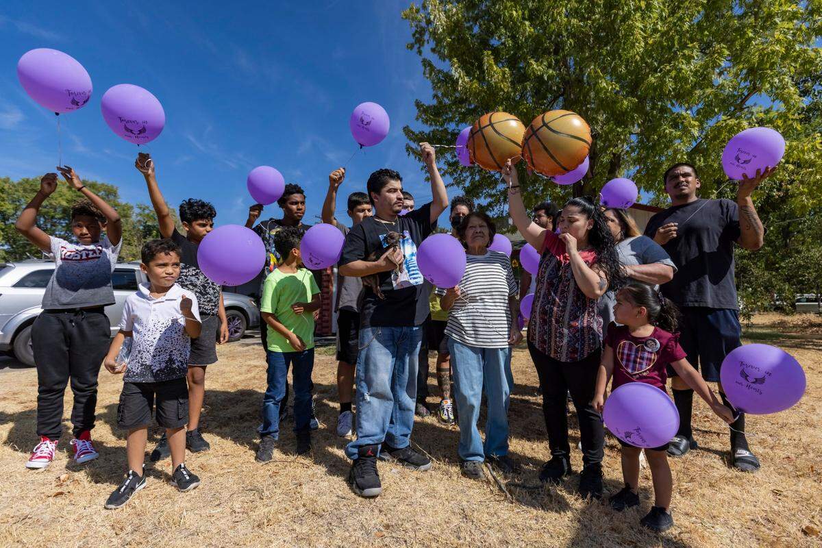Family and friends say a few words before releasing the balloons to honor Mikael Tirado in Rancho Cordova on Monday, Sept. 6, 2021. Tirado, who was 23, died Sept. 7, 2020, from an accidental overdose from a pill that was illegally pressed as Percocet but contained fentanyl.