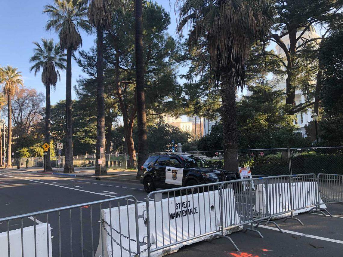 Tenth Street outside the west steps of the California state Capitol is blocked by steel and concrete barriers ahead of potential demonstrations Sunday morning, Jan. 17, 2021. The Capitol building remains surrounded by National Guard troops and law enforcement officers in anticipation of violent protests between supporters of President Trump and counter demonstrators.