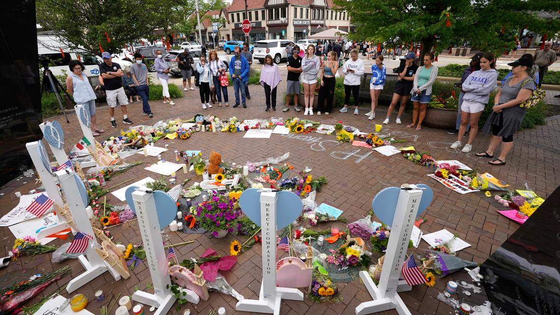 Area residents visit a memorial to the seven people who lost their lives in the Highland Park, Ill., Fourth of July mass shooting, Wednesday, July 6, 2022, in Highland Park. (AP Photo/Charles Rex Arbogast)