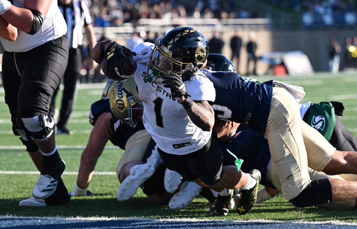Sacramento State Hornets running back Jamar Curtis (1) lunges into the end zone for a touchdown in the second half against the UC Davis Aggies defense in the Causeway Classic on Saturday, Nov. 22, 2025 in Davis.