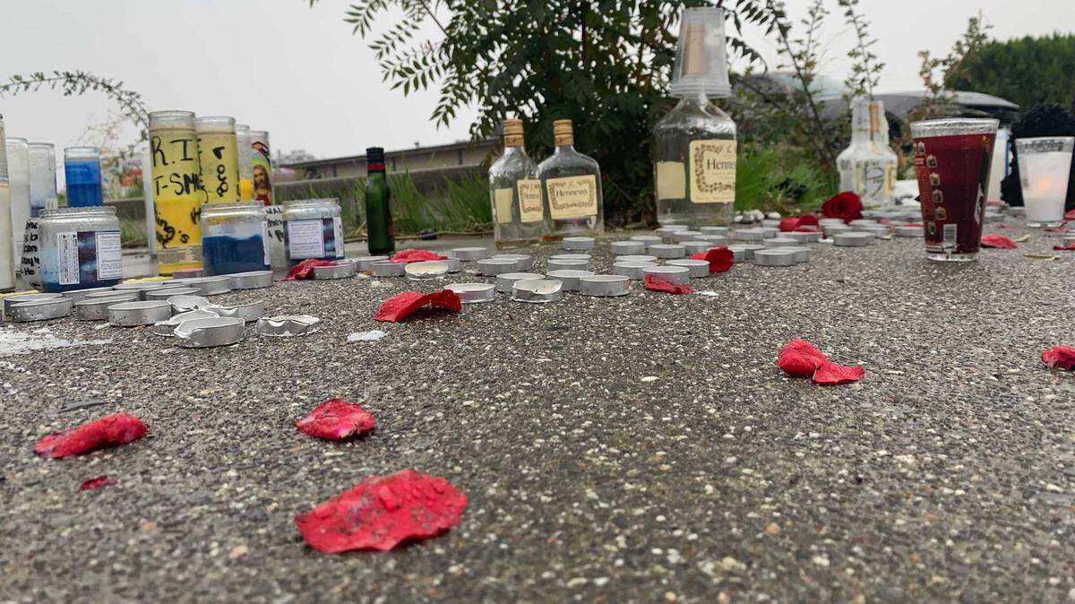 People created a makeshift memorial with candles, rose petals and other items outside the Royal Castle Banquet Hall, where two men were killed and fiver other people were injured in a shooting Saturday Oct. 30, 2021, during a large Halloween party in Sacramento County, California.