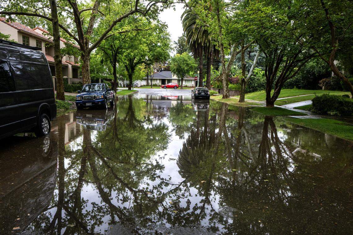Rain floods a section of 38th Street near Folsom Boulevard in Sacramento on Saturday, April 11, 2026, during a weekend storm.