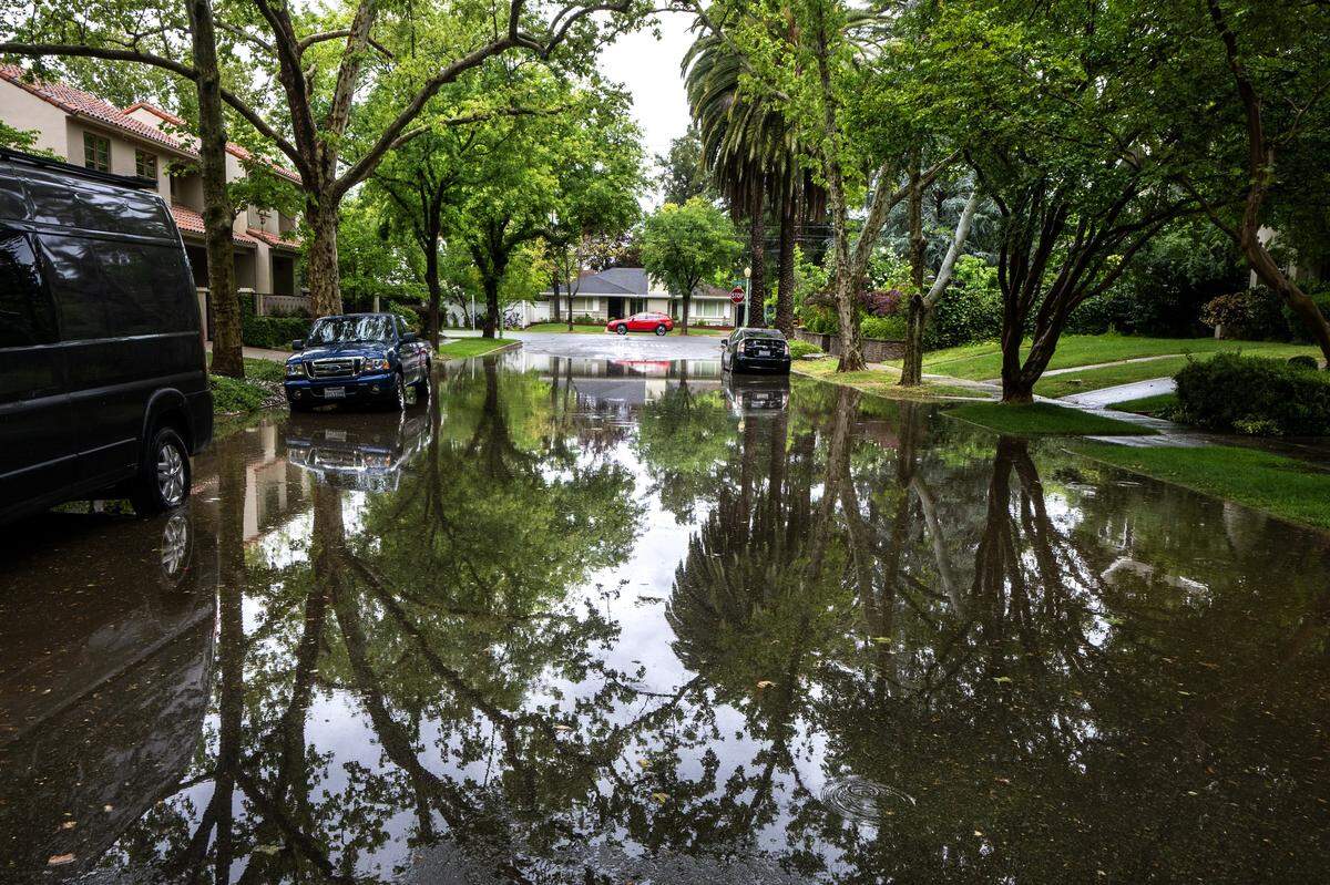 Rain flooded a section of 38th Street near Folsom Boulevard in Sacramento on Saturday, April 11, 2026, during a weekend storm passing through Northern California.
