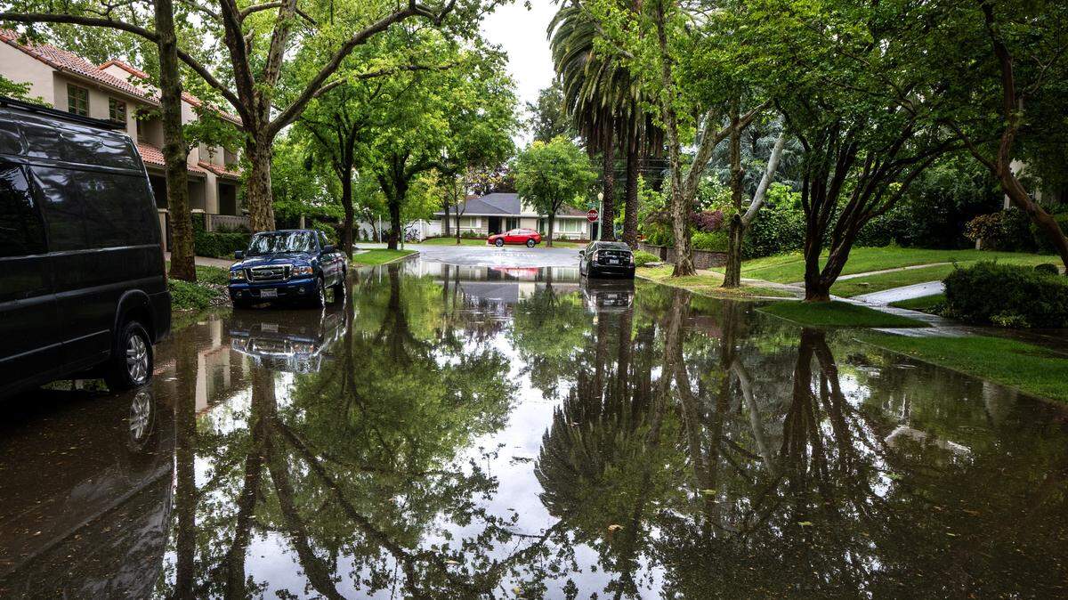 Rain flooded a section of 38th Street near Folsom Boulevard in Sacramento on Saturday, April 11, 2026, during a weekend storm passing through Northern California.