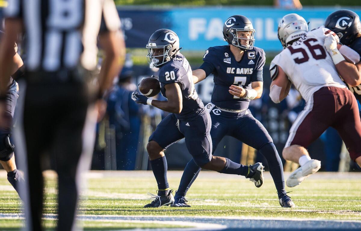 UC Davis Aggies running back Jordan Fisher (20) takes a handoff from quarterback Miles Hastings (7) during the second quarter against the Montana Grizzlies at the NCAA college football game Saturday, Oct. 7, 2023, at UC Davis Health Stadium.