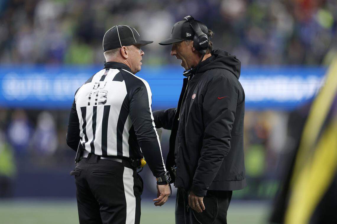 SEATTLE, WASHINGTON - JANUARY 17: Head coach Kyle Shanahan of the San Francisco 49ers speaks to an official during the second quarter against the Seattle Seahawks in the NFC Divisional Playoff game at Lumen Field on January 17, 2026 in Seattle, Washington. (Photo by Harry How/Getty Images)