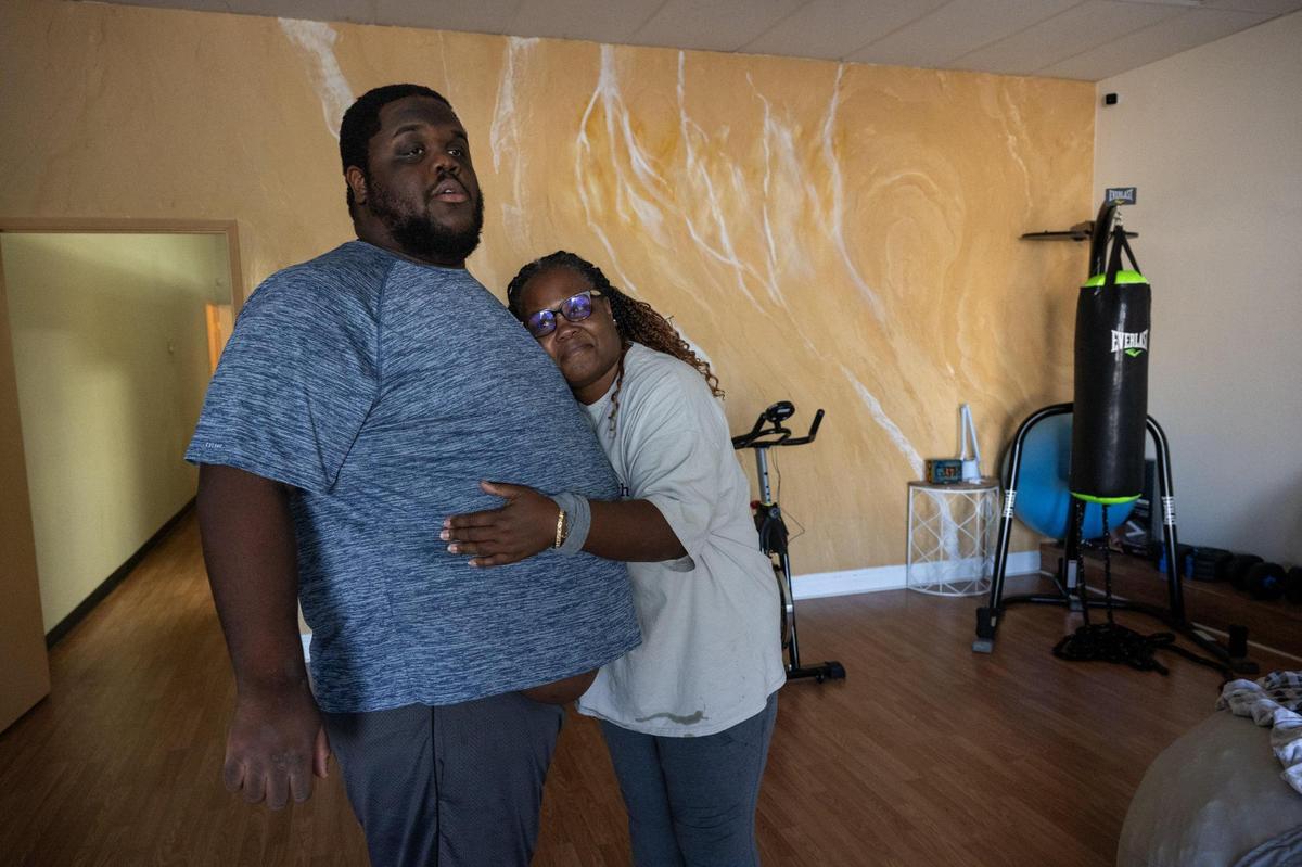 Benita Shaw Ayala’s and her 21-year-old autistic and non-verbal son, Christopher, hug inside of The Gift Foundation center where her son learns independent living skills in Citrus Heights Wednesday, Aug. 30, 2023. Christopher Alaya had been served for many years by Sacramento’s Alta Regional Center. Benita Shaw- Ayala took part in a state grant program last year and became certified in person-centered thinking — the concept of developing a care plan for a person with disabilities based on how they want to live.