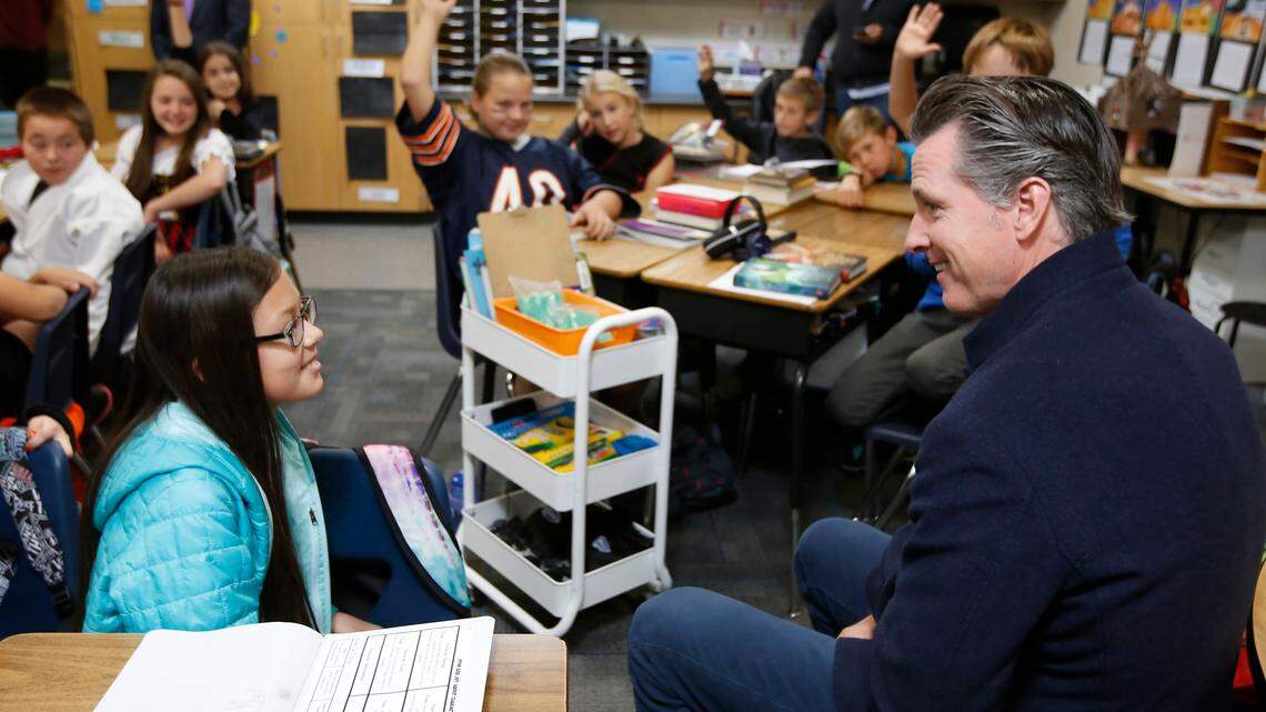 Gov. Gavin Newsom talks with fifth grade student Oma Nelson, left, during his visit to the Blue Oak Elementary School in Cameron Park on Thursday, Oct. 31, 2019. The state’s largest teachers union voted Saturday to defend Newsom in an upcoming recall election.