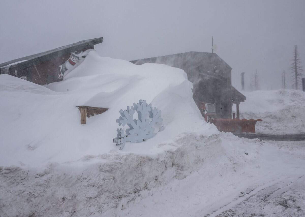 A flurry of snow falls on a shop at Sierra-at-Tahoe on Monday, March 6, 2023. A near-record amount of snow has fallen in the Sierra Nevada over the past few weeks.