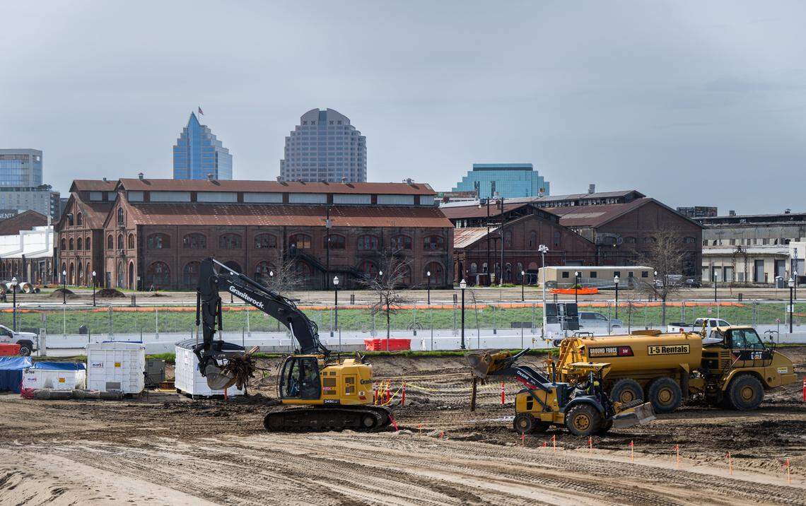 Workers move construction equipment on the future grounds of the Kaiser Permanente Railyards Medical Center in March 2025. The center will feature a new eight-story hospital with 310 beds in private rooms. 