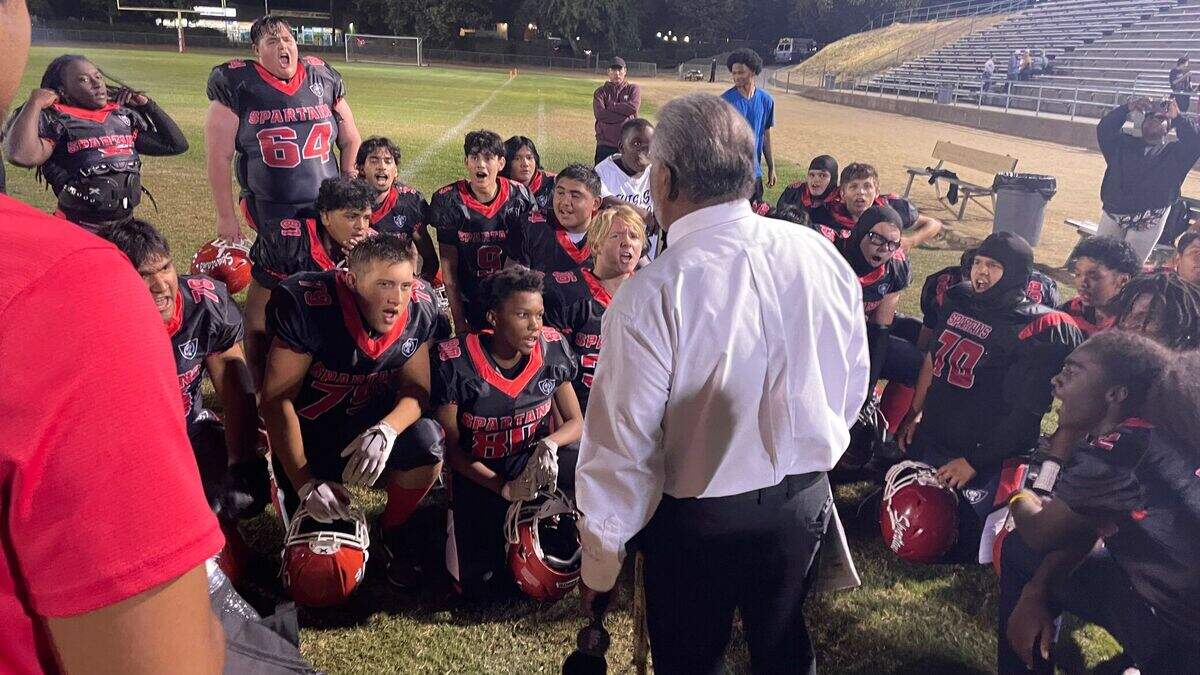 San Juan Spartans coach David Castillo talks to his team after it won its first game of the season Friday in Citrus Heights.