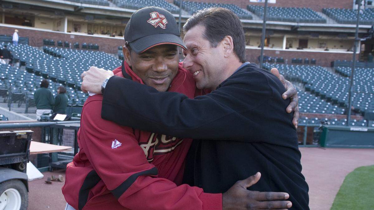 Sports announcer Greg Papa, right, hugs Houston Astros infielder Miguel Tejada before a game May 12, 2008, at the Giants’ AT&T Park. Papa, who has been the radio voice of the Raiders since 1997, is reportedly being replaced by Brent Musburger.