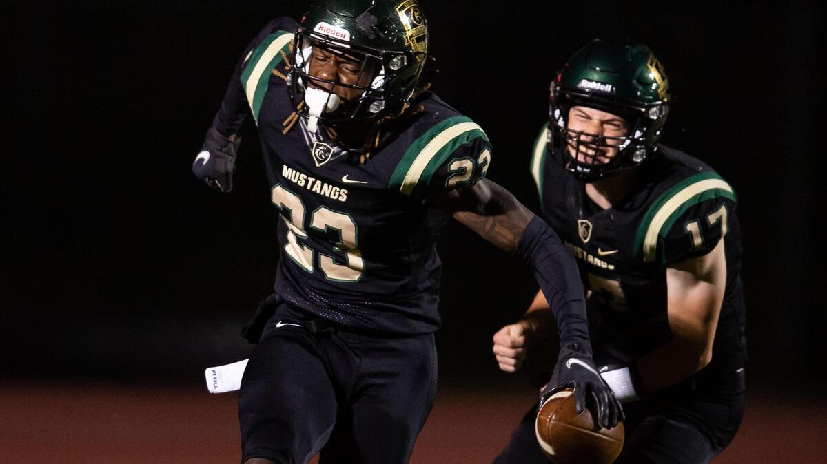 Monterey Trail’s Otha Williams yells after a touchdown run to end the first quarter against Cosumnes Oaks, as quarterback Frank Arcuri follows behind, during the high school football game Friday, April 2, 2021, at Monterey Trail High School in Elk Grove. Monterey Trail beat Cosumnes Oaks 57-21.