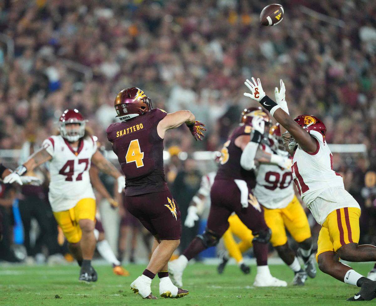 Arizona State Sun Devils running back Cameron Skattebo (4) throws a pass on a fake punt attempt against the USC Trojans during the first half Saturday, Sept. 23, 2023, at Mountain America Stadium in Tempe, Arizona.