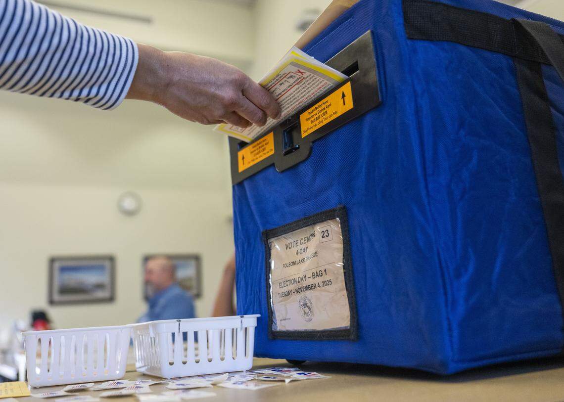 A Folsom resident inserts a ballot as she votes on Proposition 50 at Folsom Lake College on Tuesday.