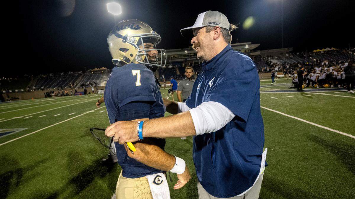 UC Davis Aggies quarterback Miles Hastings (7) is congratulated by head coach Tim Plough after their victory against the Idaho Vandals on Saturday at UC Davis Health Stadium.