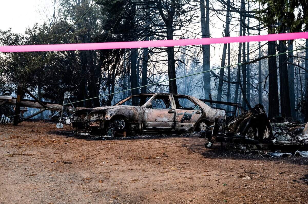 A melted car stands on the rubble of a burned down home during the River Fire on Mount Olive Road in Chicago Park on Thursday, Aug. 5, 2021.