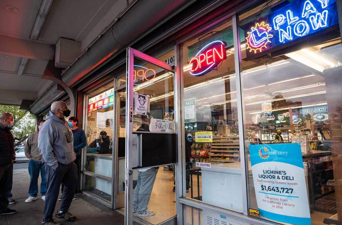 People wait in line at Lichine’s Liquor & Deli on South Land Park Drive in Sacramento to buy tickets for the Mega Millions lottery in 2021. On Tuesday, March 20, 2024, lottery officials said a ticket worth $1.7 million was sold at the South Land Park retailer.