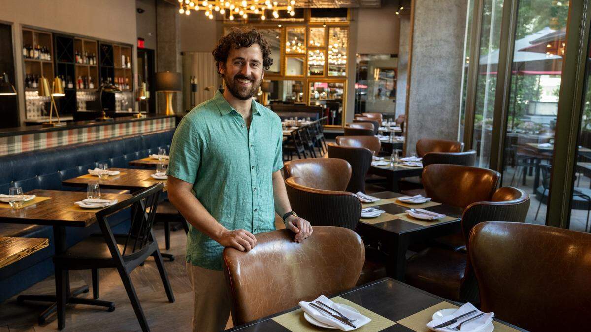 The Sacramento Bee food and drink reporter Benjy Egel, photographed on Aug. 29, 2023, standing in the dining room of Camden Spit & Larder in downtown Sacramento, authored “Sacramento Eats: Recipes from the Capital Region’s Favorite Restaurants.”