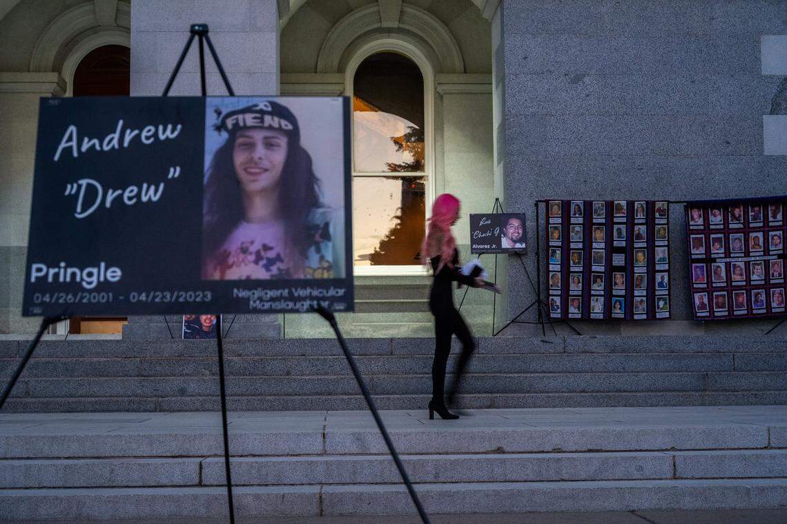 Erika Pringle walks in between a display of homicide victims, including one of her brother Andrew Pringle, left, after speaking at a National Day of Remembrance at the state Capitol in Sacramento on Sept. 25. She plans to host an event for vehicular homicide at the Capitol on Sunday, Nov. 16.
