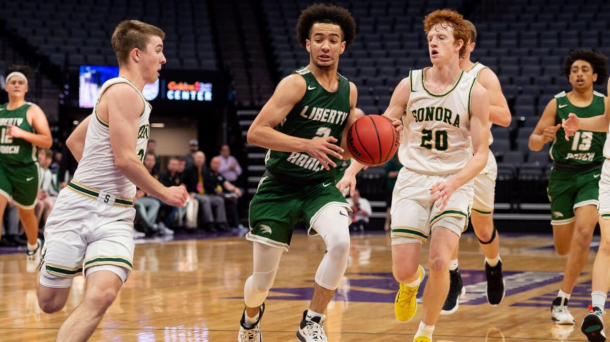 Liberty Ranch’s Jalen Patterson, center, drives to the hoop as Sonora’s Austin Patterson, right, follows during the third period of the high school boys basketball Sac-Joaquin Section Division IV championship Thursday, Feb. 27, 2020, at Golden 1 Center in Sacramento. Sonora beat Liberty Ranch 70-57 for a repeat at the Division IV title.