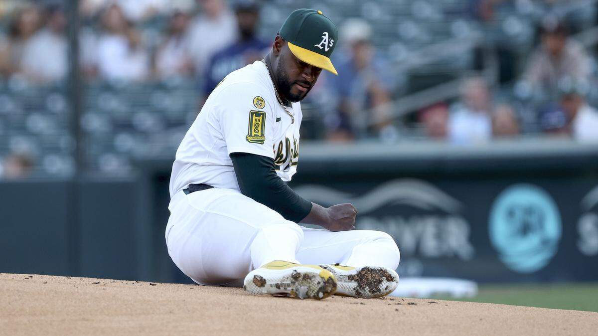Athletics starting pitcher Luis Severino slips and looks at his feet after throwing a pitch against the Seattle Mariners during the first inning Tuesday at Sutter Health Park in West Sacramento.