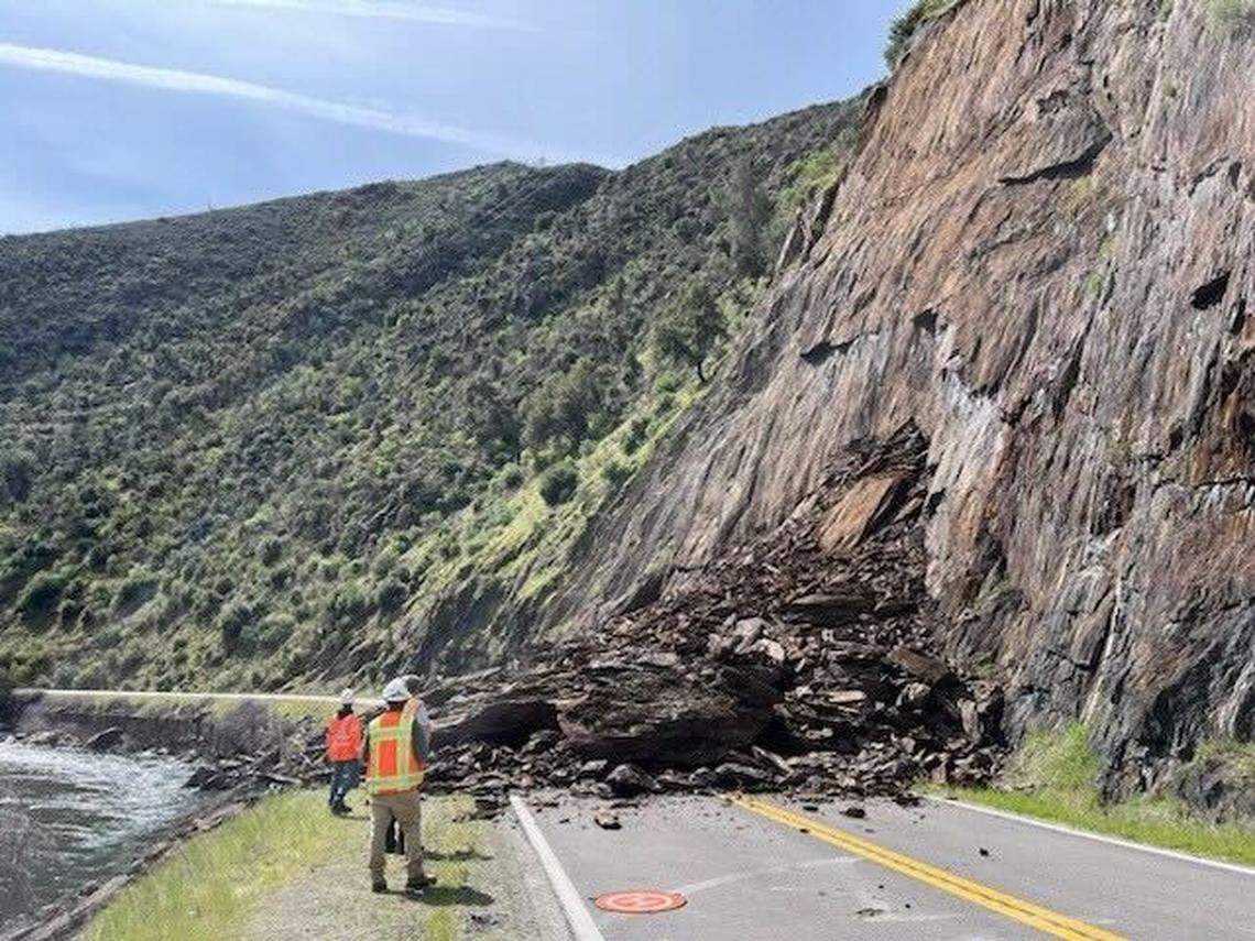 Workers inspect a debris slide that closed Highway 140 near the entrance to Yosemite National Park on Thursday, March 20, 2024.