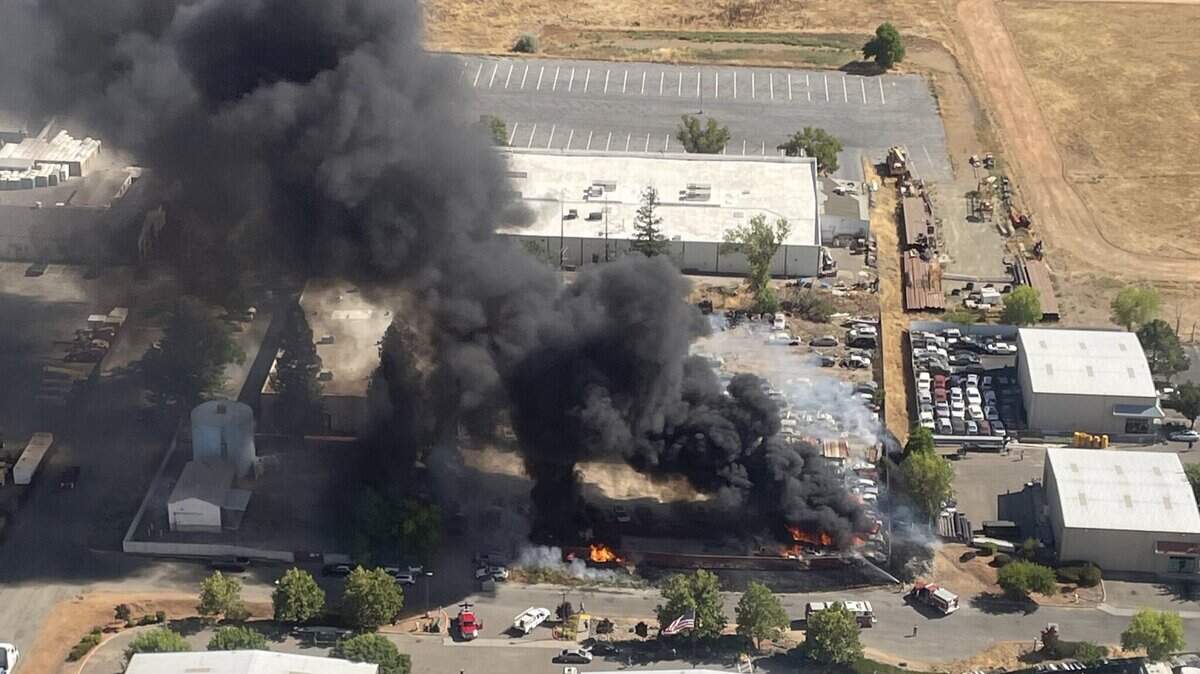 A fire blazes in an auto dismantling yard near Security Park Drive and Quicksilver Drive in Rancho Cordova on Monday, Aug. 14, 2023. Firefighters with the Sacramento Metropolitan Fire District extinguished the fire in roughly 40 minutes, according to district spokesman Capt. Parker Wilbourn.