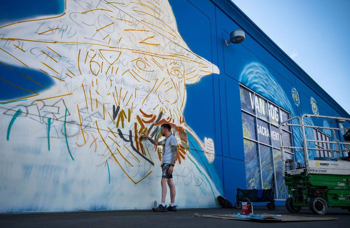 Muralist Arthur Brouthers, of Charlotte, N.C., paints a portrait of Dutch artist Vincent Van Gogh on the side of a building facing Jefferson Boulevard in West Sacramento on Wednesday, June 22, 2022, for an immersive art experience that is planned to open soon.