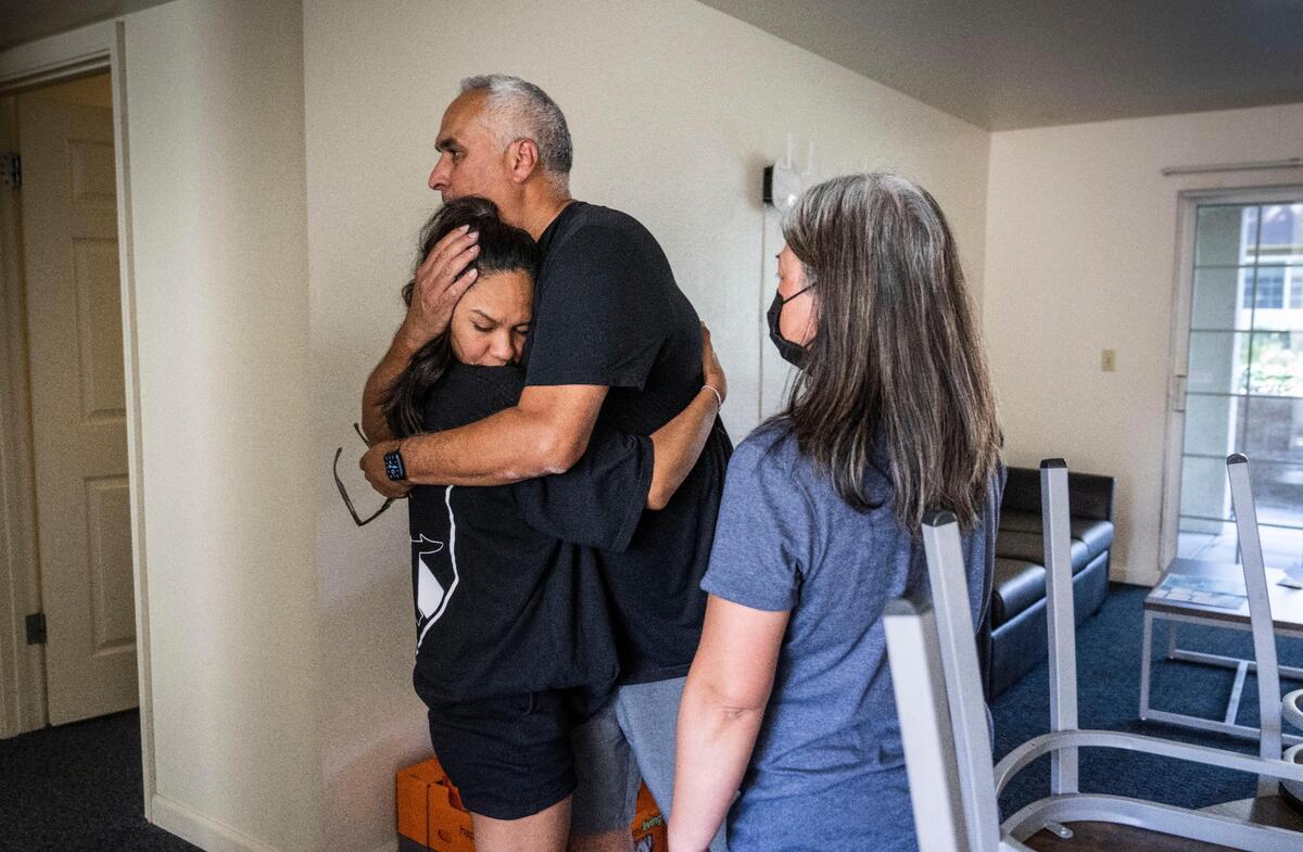 Rosemarie Baldovinos, of El Dorado Hills, gets a hug from her father Ricardo as mother Rouella waits her turn during move in day at Sonoma State on Tuesday.