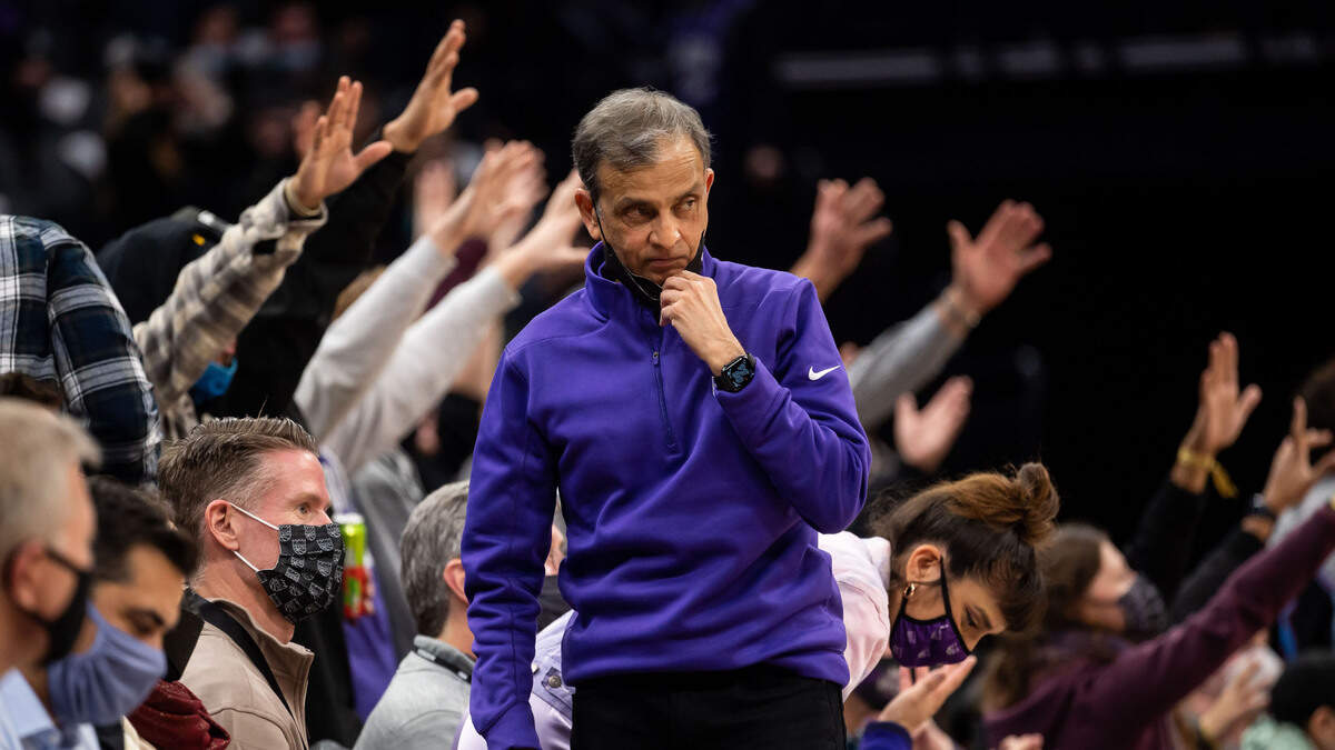 Sacramento Kings owner Vivek Ranadivé settles back in to take his court-side seat after posing with someone for a photo during a break in action between the Kings and the Atlanta Hawks during the fourth period of the NBA basketball game Wednesday, Jan. 5, 2022, at Golden 1 Center in Sacramento. The Hawks beat the Kings, 108-102.