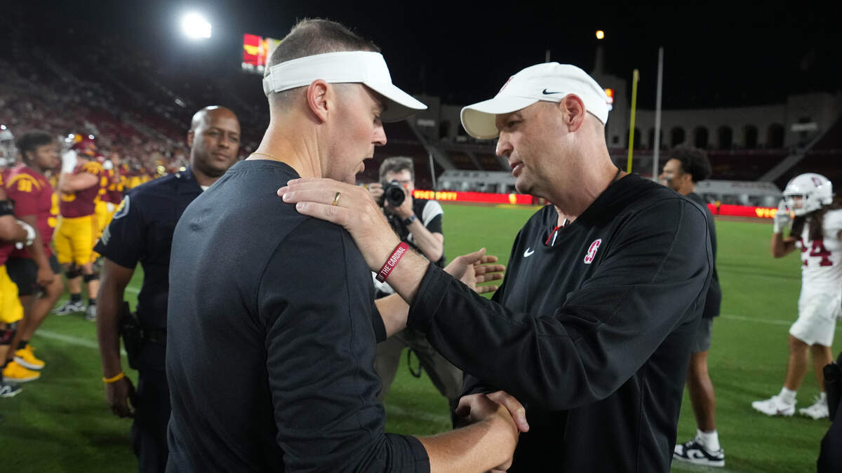 USC Trojans head coach Lincoln Riley, left, talks with Stanford Cardinal head coach Troy Taylor after the game Saturday at United Airlines Field at Los Angeles Memorial Coliseum.