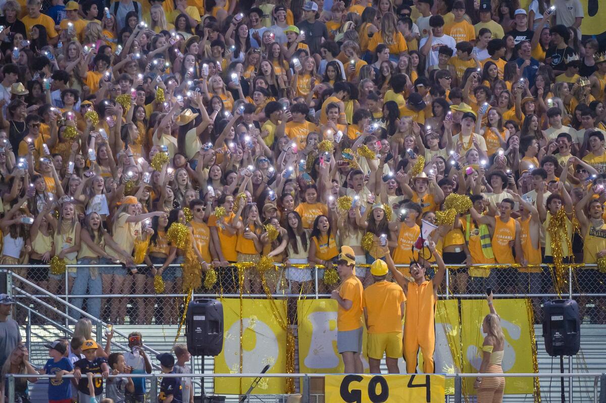The Oak Ridge High School student section lights their cell phones and cheers on Friday during a home game in El Dorado Hills.
