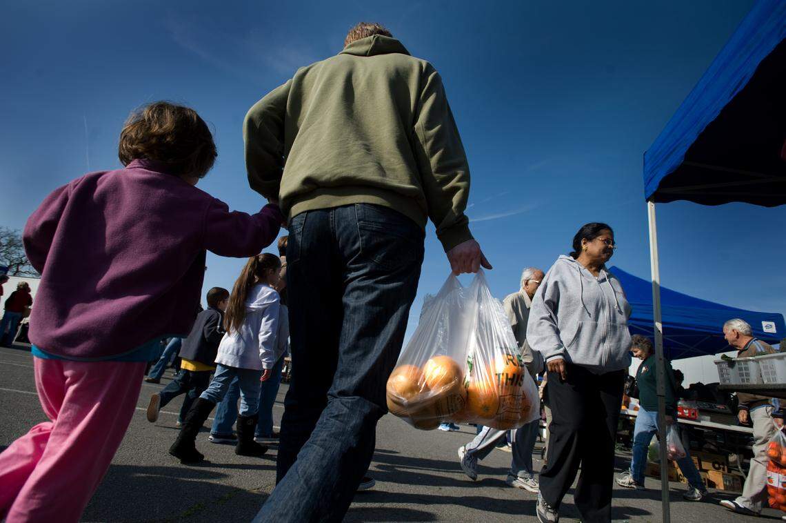 Shoppers make their way around looking for fresh produce at the Sunrise Mall farmers market in February 2010.