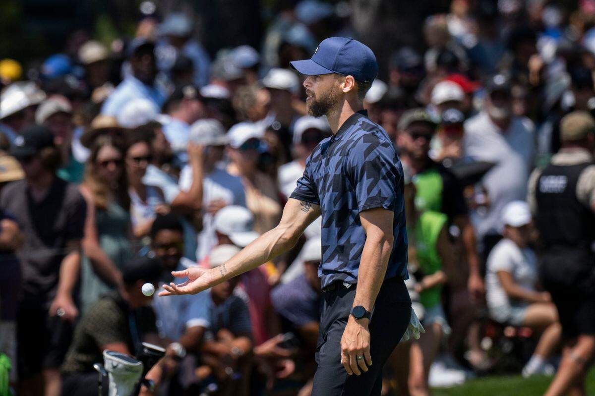 The Golden State Warriors’ Stephen Curry throws a ball to fans after making his last shot during the final day of the American Century Championship celebrity golf tournament at Edgewood Tahoe Resort in Stateline, Nev., on Sunday, July 13, 2025.